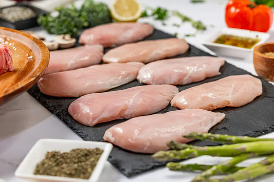 Butchers Bundle: Raw chicken breasts delivered to your door, beautifully presented with asparagus, herbs, spices, mushrooms, tomato, lemon half, and seasoning. No antibiotics ever or added hormones or seed oils.