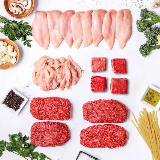 The Essentials Box includes free range chicken breasts, sliced chicken, locally sourced ranch steak , and ground beef. Here is a layout of all those cuts, with mushrooms, herbs, spices, garlic, olive oil, salt, and uncooked pasta surrounding it.